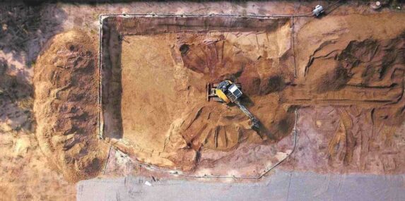 excavator on a construction site excavates a cellar