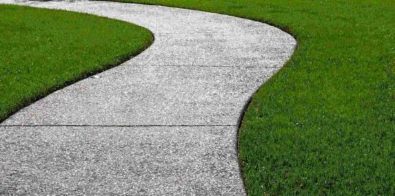 carpet of zoysia grass and an oyster shell tabby pathway suggest the abstract concept of a journey