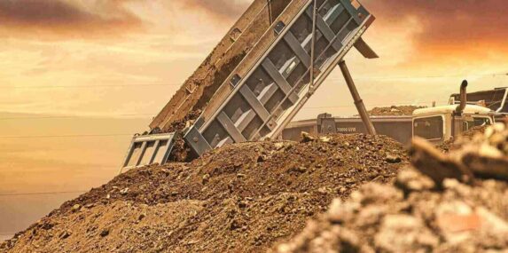 truck unloading dirt to fill a dirt gap