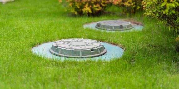 cesspool on the backyard green lawn