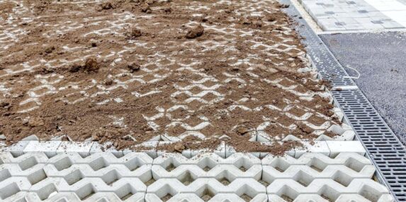 leveling ground at new parking place by removing excess material