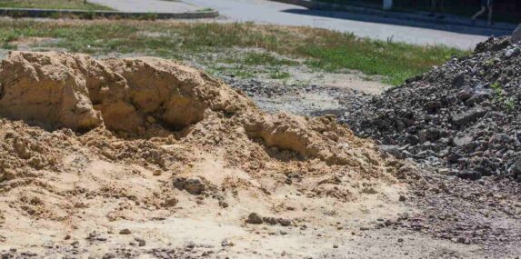 big mountain of yellow sand at construction site close up