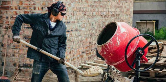 experienced worker works on the construction of a FL brick house