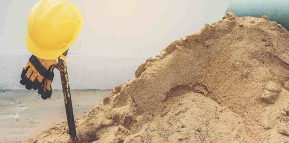 yellow helmets gloves and shovel on Central Florida sand pile