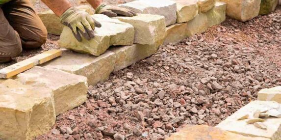 South West Florida man landscaping with natural stones