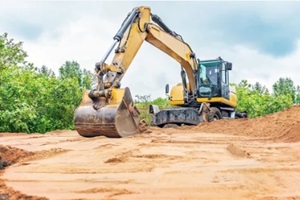 excavator aligns surface of sand
