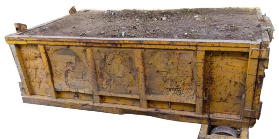 isolated industrial dumpster filled with dirt