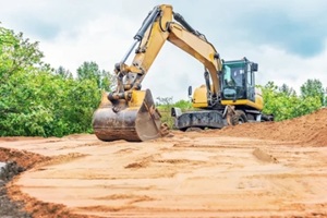 excavator aligns surface of construction sand
