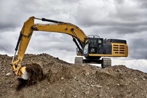 constuction industry excavator heavy equipment digging on gravel