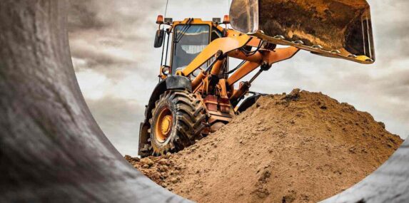 heavy construction equipment excavator hauls construction sand on Punta Gorda construction site