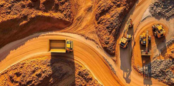 aerial view of construction vehicles on winding dirt road to Punta Gorda, FL quarry