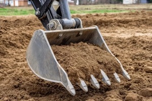 excavator bucket filled with soil