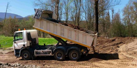 white dump truck unloading soil at a construction site in Punta Gorda, FL