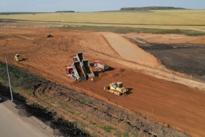 Construction Site with Dump Trucks Unloading Fill Dirt and Bulldozer Leveling Ground in Lakeland, FL