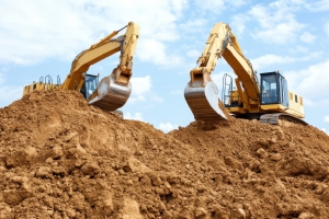 Excavators Working on Dirt Filling on Floodway
