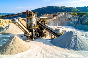 Piles of Aggregate Sand Near Processing Machinery