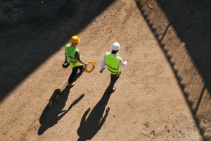 Two Engineer Walking on Dirt Surface to Check Stability