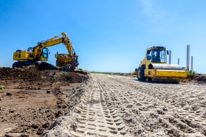 Heavy Machines Laying Fill Dirt on Construction Site