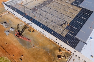 Piles of Aggregate Material with Crane Near an Under Construction Warehouse in Lakeland