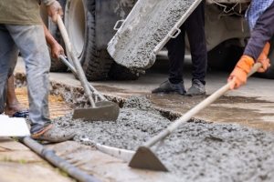 Workers Pouring Crushed Concrete for Repairing Washed Out Driveway