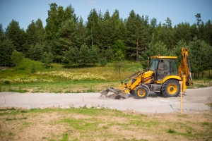 Excavator Spreading White Sand in A Backyard Beach Landscape Path