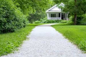 White Gravel Path Leading Towards A House in Green Garden