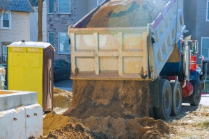 Truck Unloading Bulk Sand Outside Commercial Construction Site