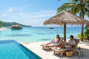 Couple Lounges on a Deck Chair on White Sand Surface by a Private Pool